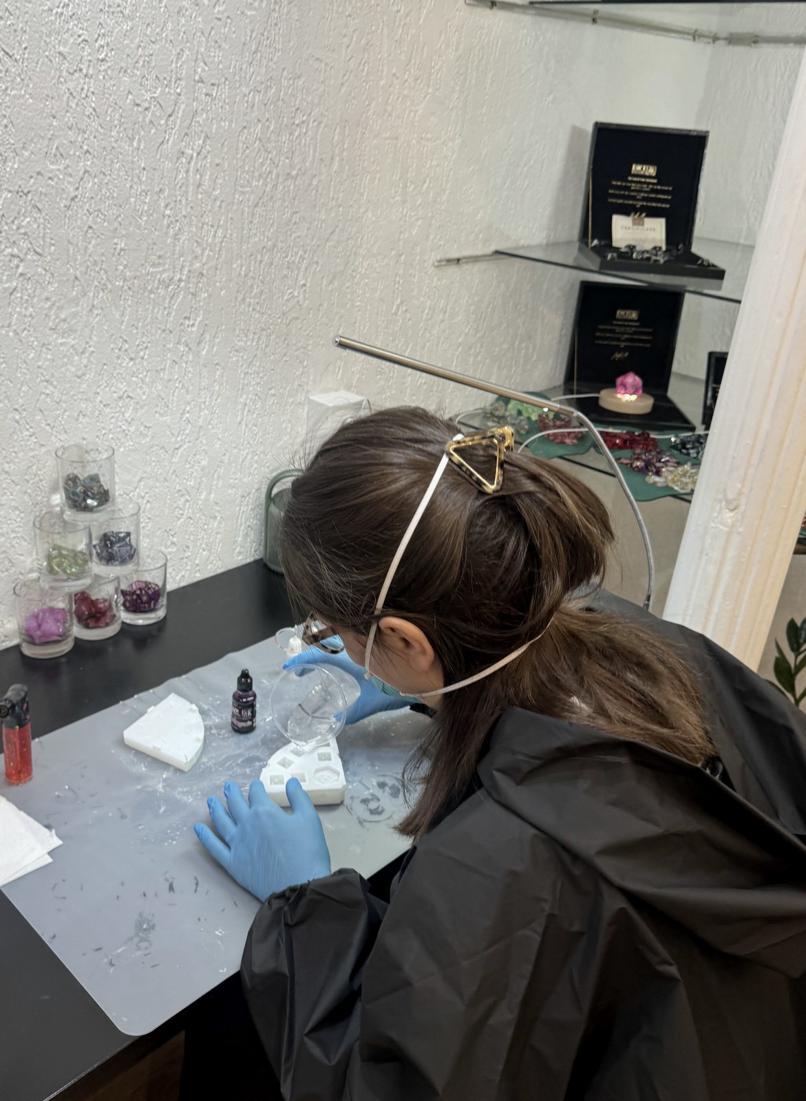 Pouring resin into dice molds during the workshop