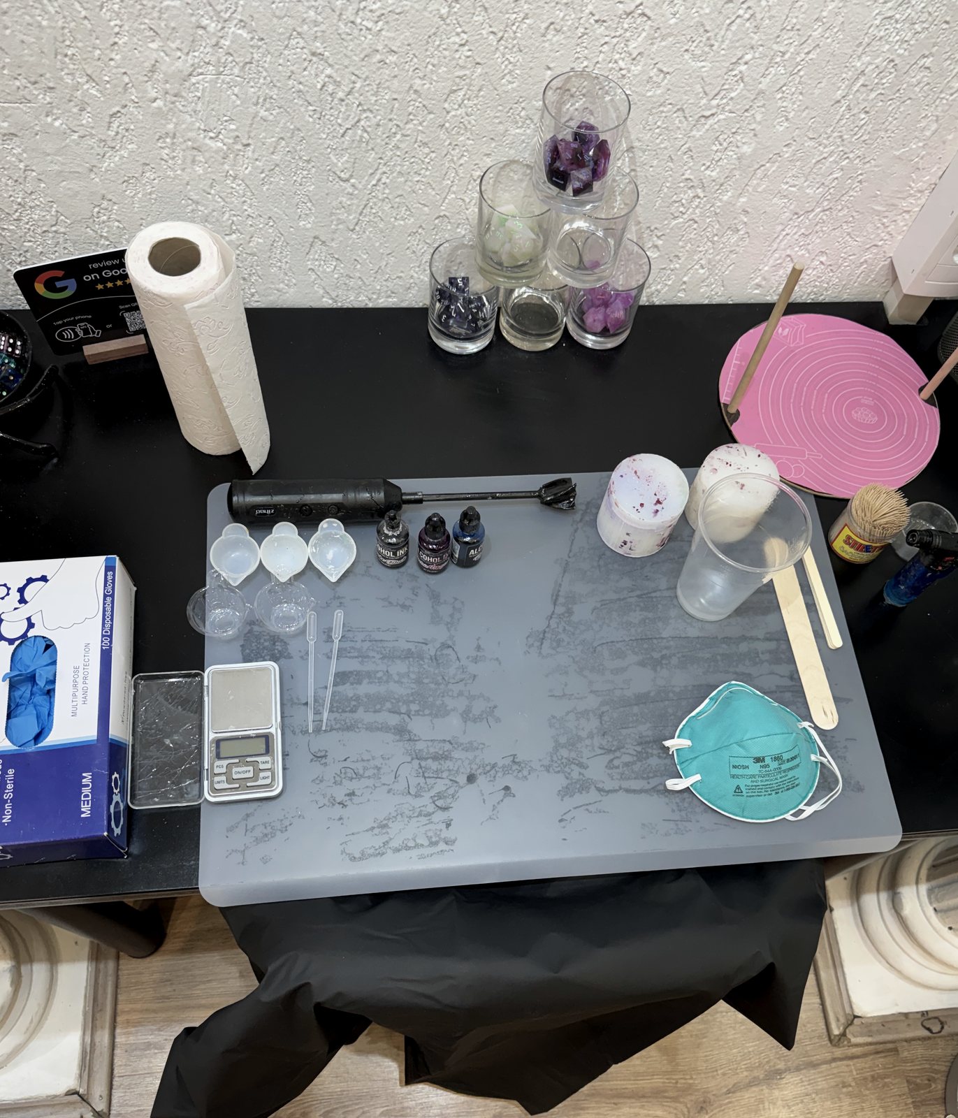 Dice making workshop table with resin, pigments and equipment
